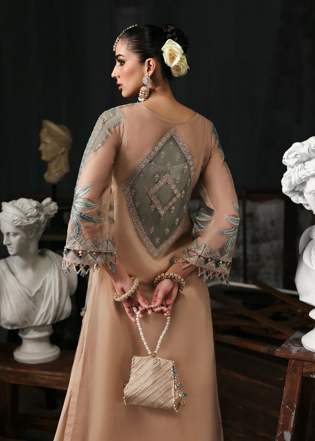 Elegant pale pink organza suit with dori work panels, applique neckline, embroidered dupatta, and raw silk trouser — perfect for festive occasions.