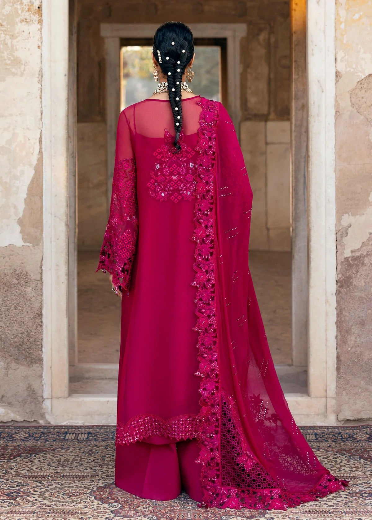 Elegant chiffon suit with hand-embellished neckline, cutwork borders, diamante dupatta with organza motifs, and raw silk trouser — ideal for festive wear.