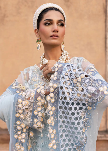 Luxury chiffon suit with hand-embellished neckline, 3D floral sleeve motifs, cutwork borders, diamante dupatta, and raw silk trouser — perfect for occasions.