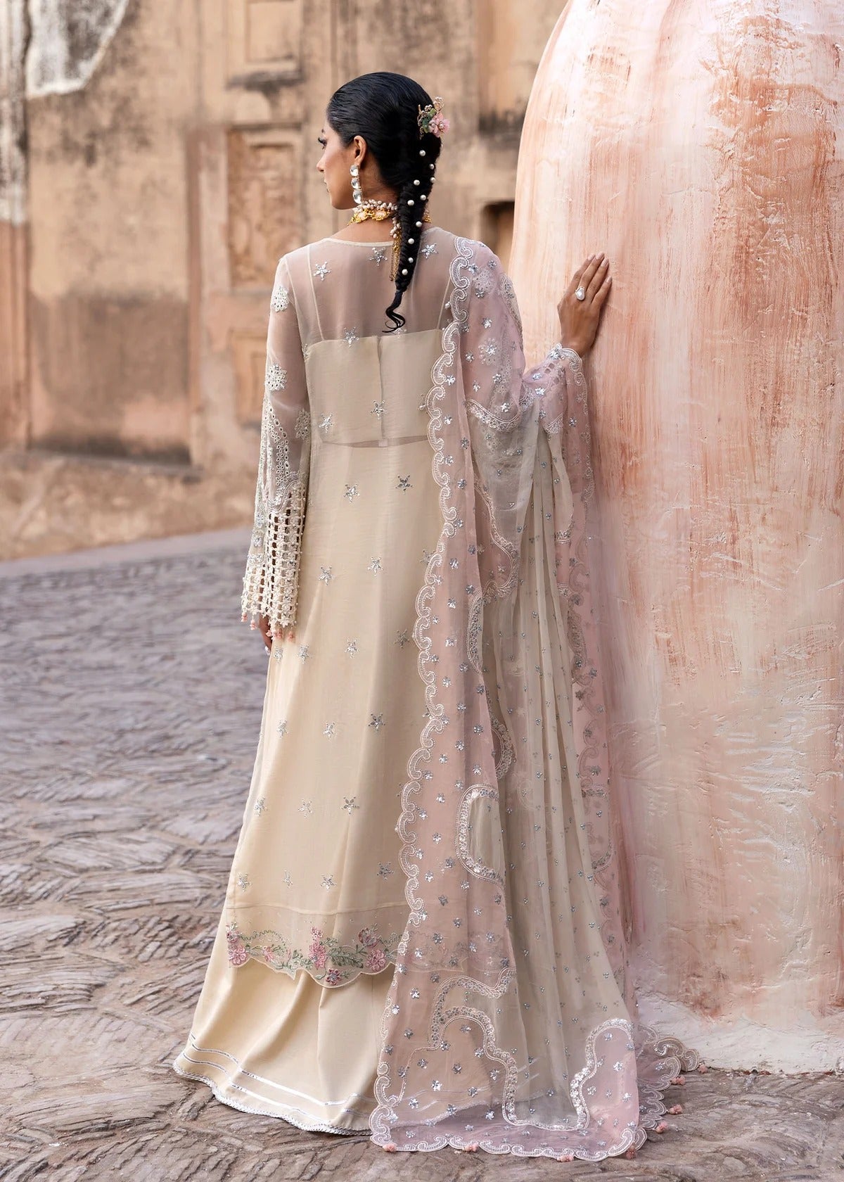 Elegant chiffon embroidered suit with hand embellishment, cutwork borders, diamante & mukesh dupatta, and raw silk trouser perfect for festive wear.