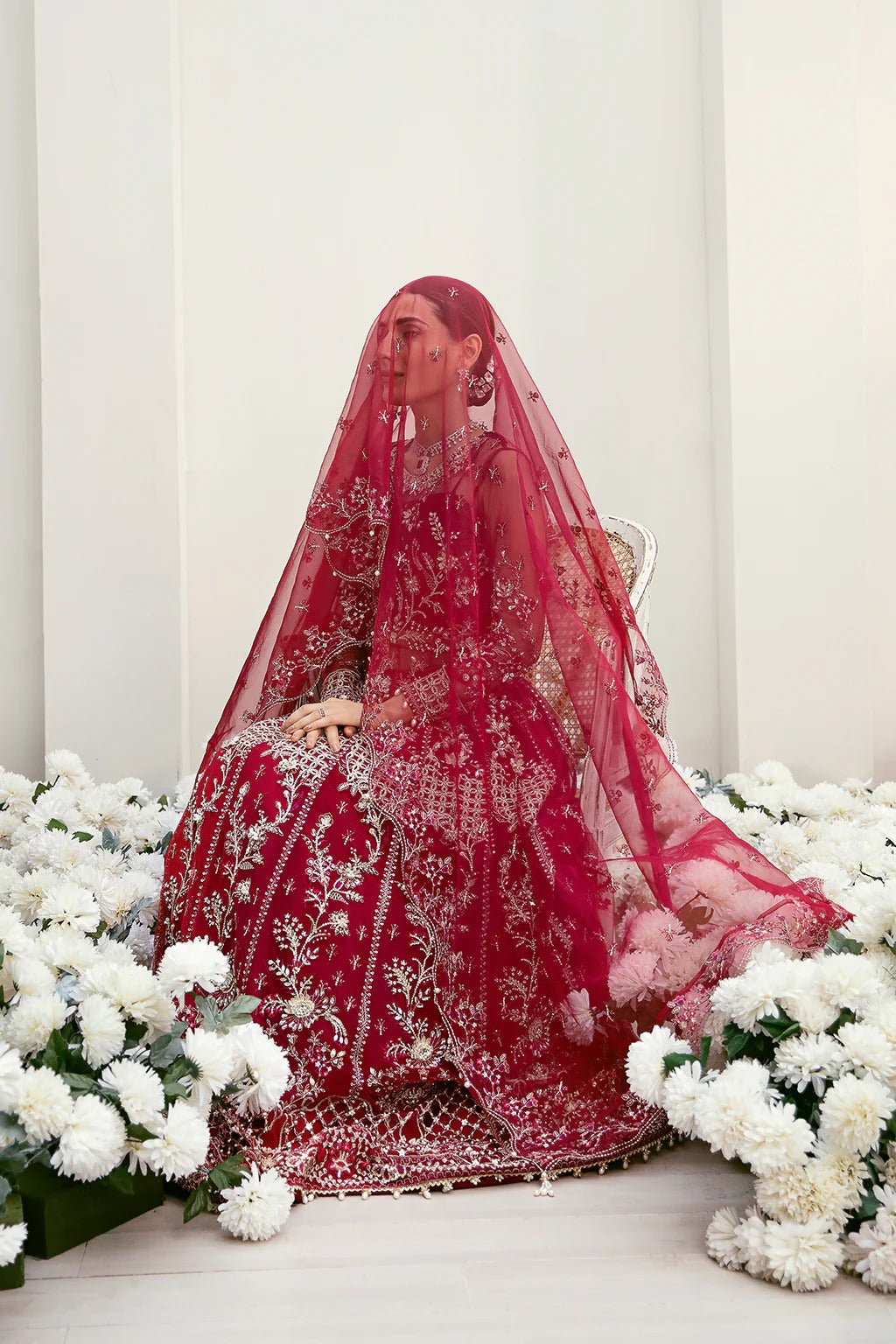 Graceful organza and poly net embroidered suit featuring hand-embellished bodice, cutwork panels, organza borders, dupatta, and raw silk trouser fabric.