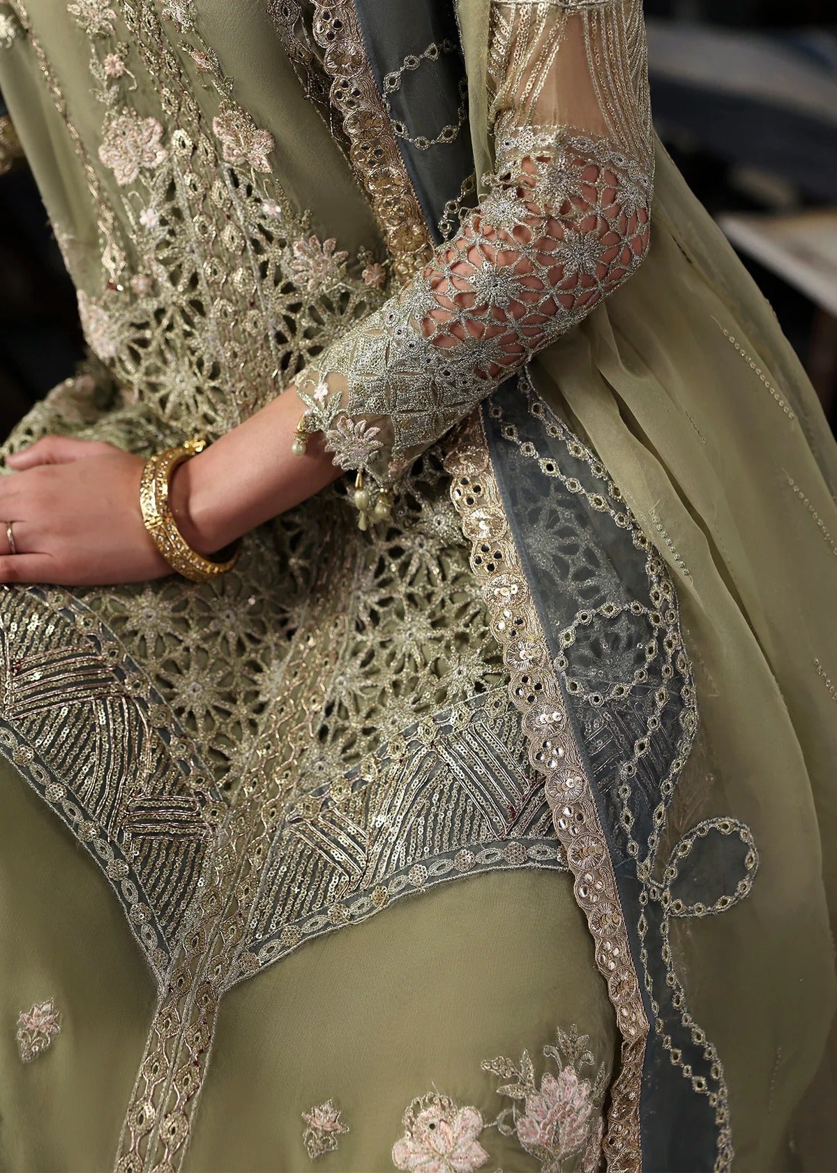 Graceful olive green organza suit with dori work, cutwork neckline, embroidered dupatta, and raw silk trouser a perfect choice for festive elegance.