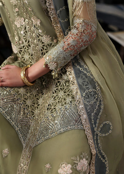 Graceful olive green organza suit with dori work, cutwork neckline, embroidered dupatta, and raw silk trouser a perfect choice for festive elegance.