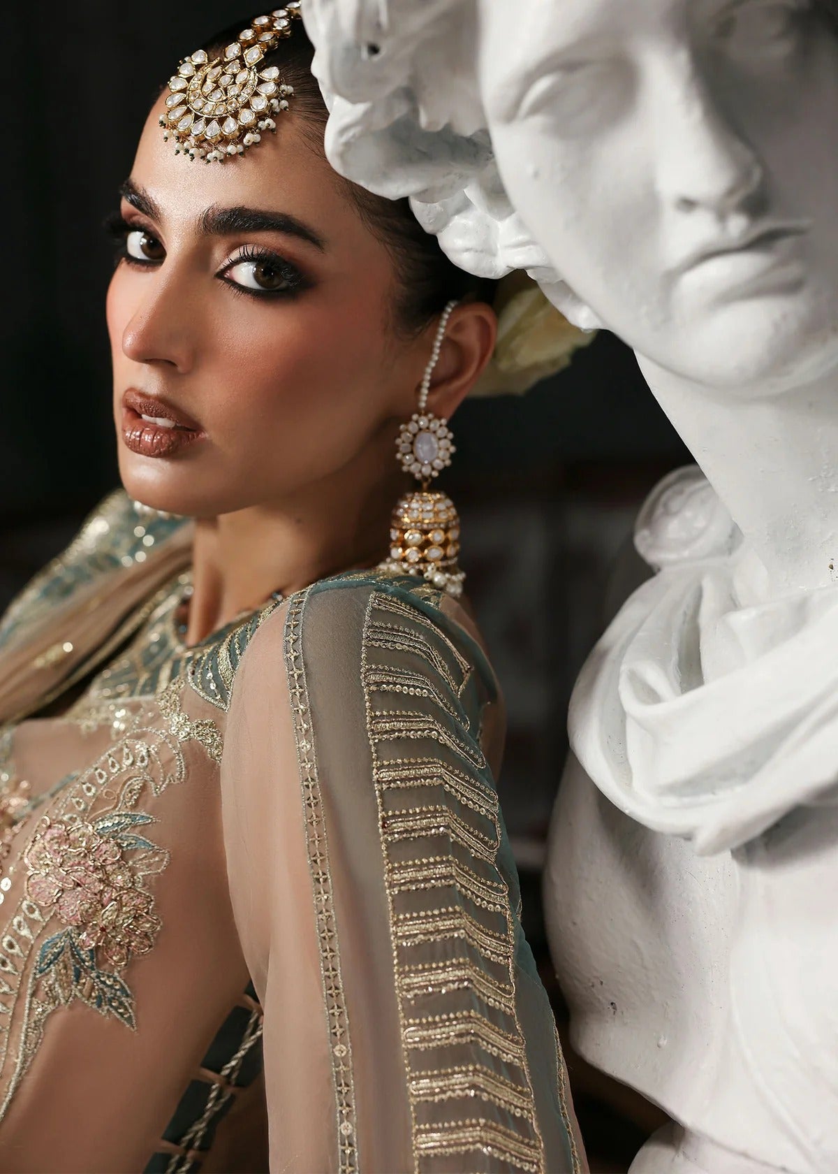 Elegant pale pink organza suit with dori work panels, applique neckline, embroidered dupatta, and raw silk trouser — perfect for festive occasions.