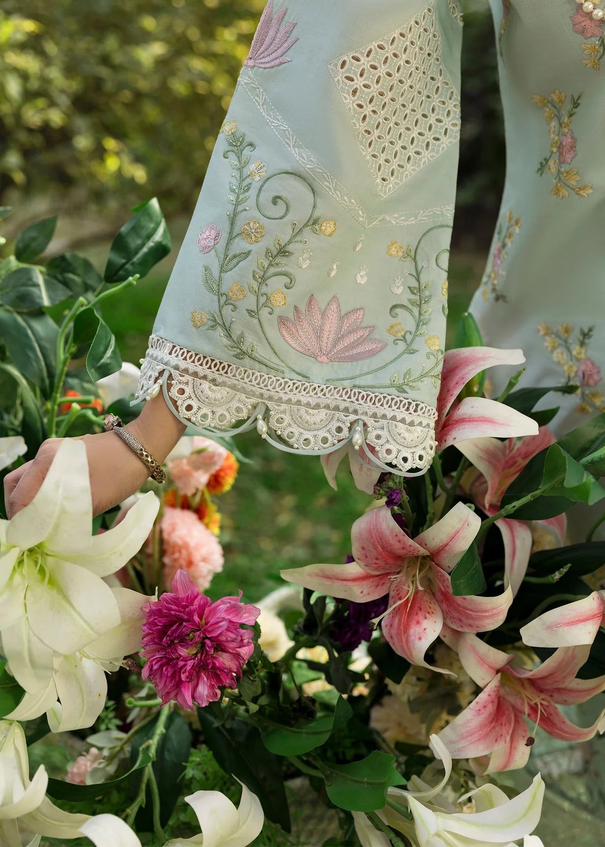 Elevate your style with this sky blue embroidered lawn suit featuring hand-work neckline, chikan-kari sleeves, net dupatta, and cotton trouser.