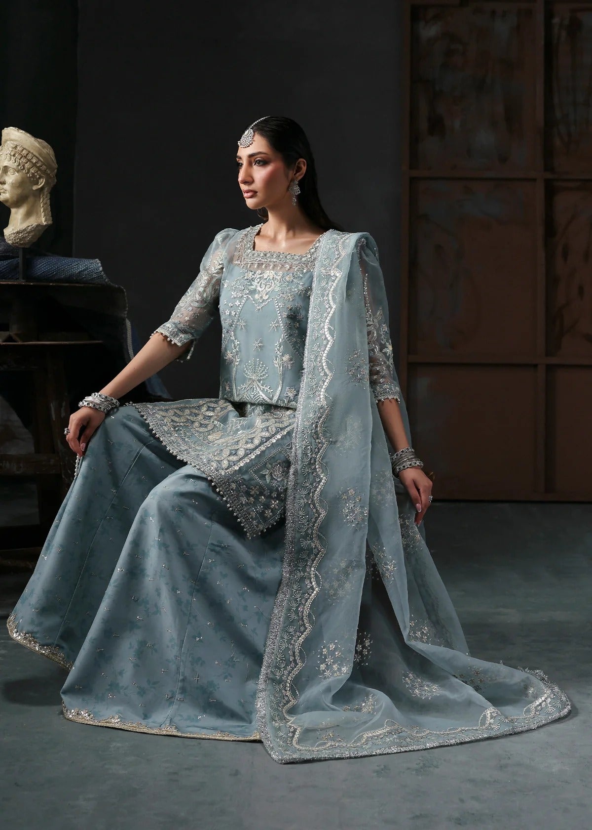 Chic ice blue organza dress with embroidered panels, dupatta & raw silk trouser. Available stitched/unstitch with custom sizing & worldwide delivery.