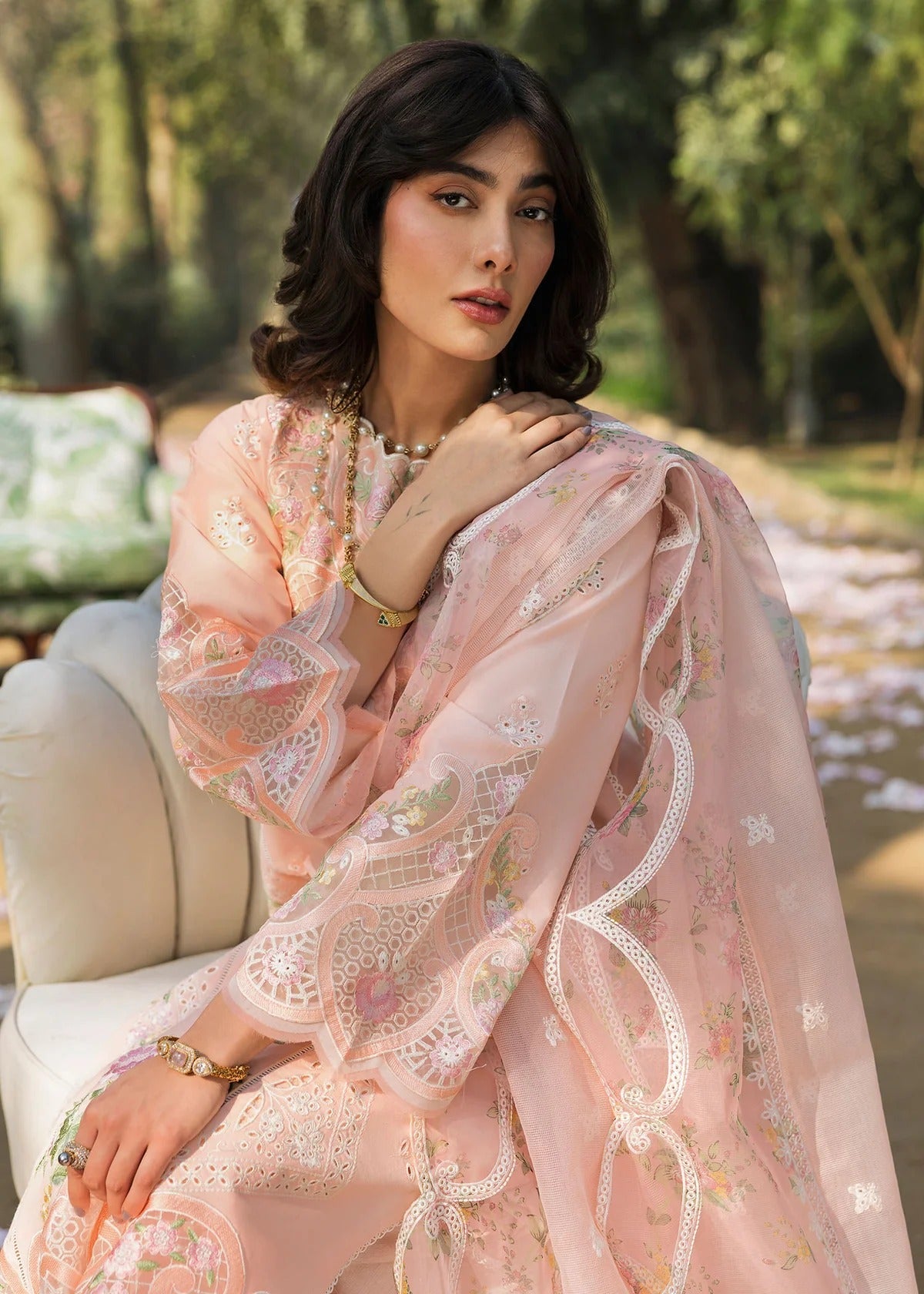 Grace your look with this peach embroidered lawn suit featuring chikan-kari panels, hand-work neckline, net dupatta, and cotton trouser.