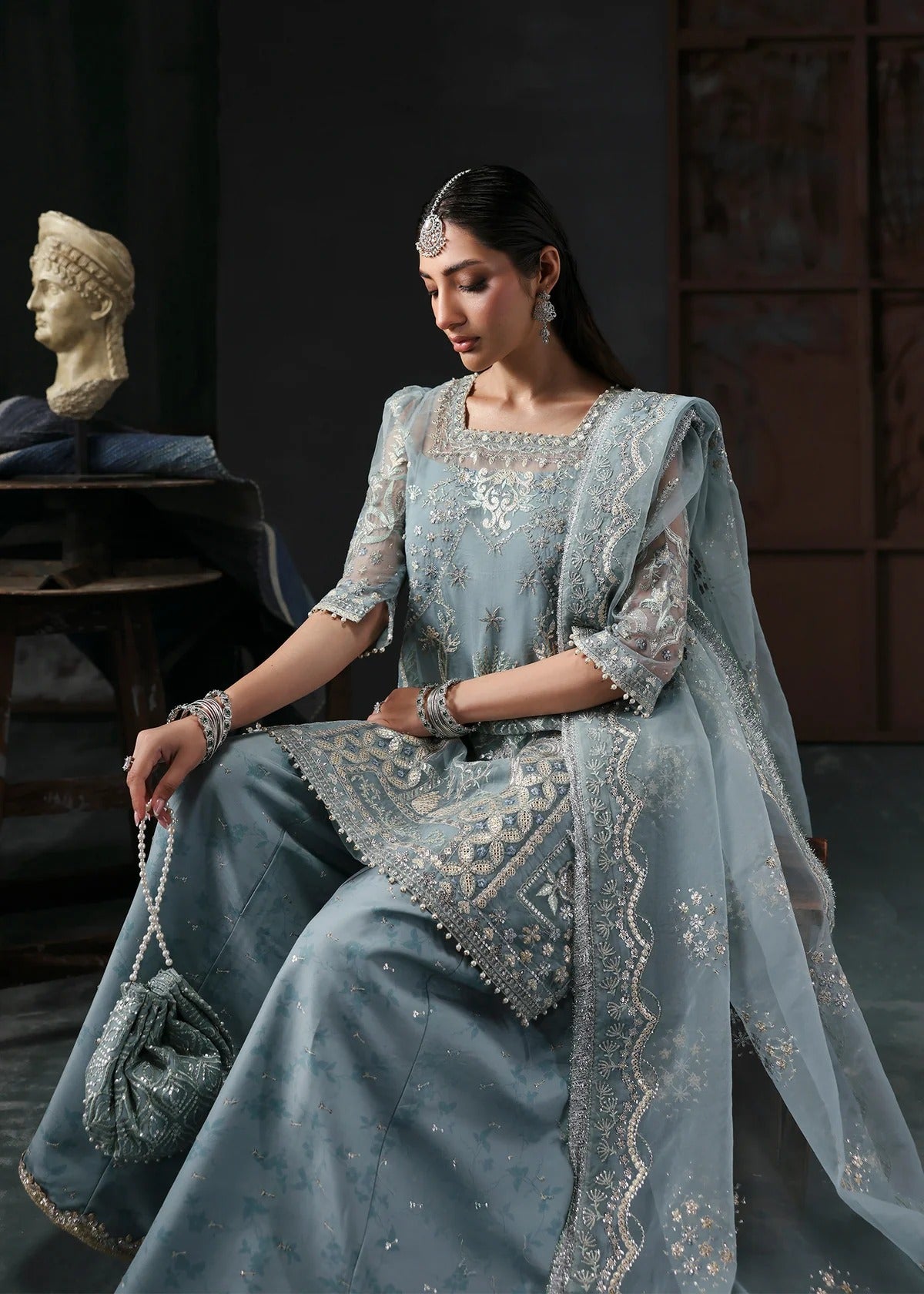 Chic ice blue organza dress with embroidered panels, dupatta & raw silk trouser. Available stitched/unstitch with custom sizing & worldwide delivery.