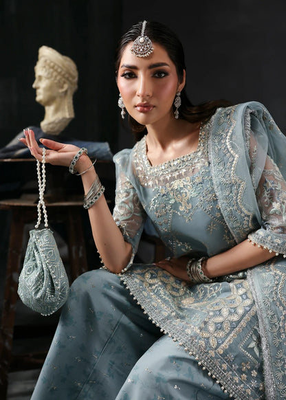 Chic ice blue organza dress with embroidered panels, dupatta & raw silk trouser. Available stitched/unstitch with custom sizing & worldwide delivery.