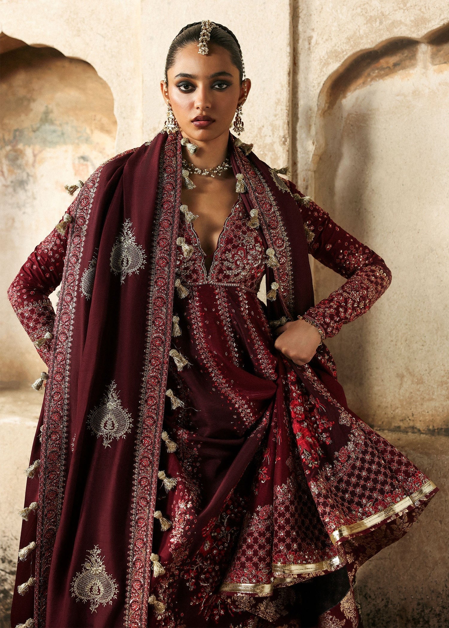 Elegant burgundy and maroon Korean raw silk pishwas with rich embroidery and matching churidar. Unstitched luxury outfit for timeless royal grace.