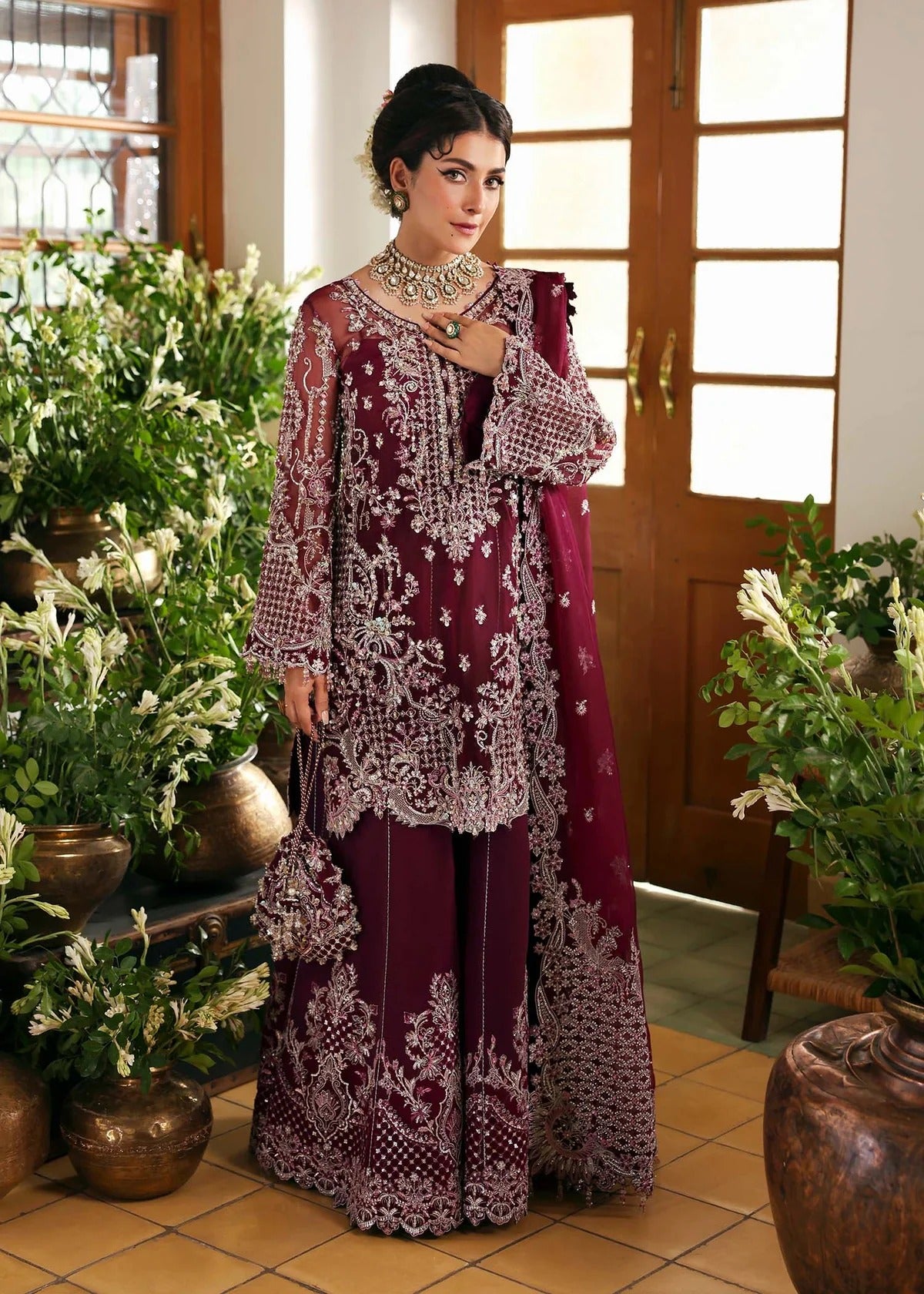 Regal imperial plum suit with hand-embellished organza panels, ornate borders, embroidered dupatta, and trouser for timeless festive elegance.