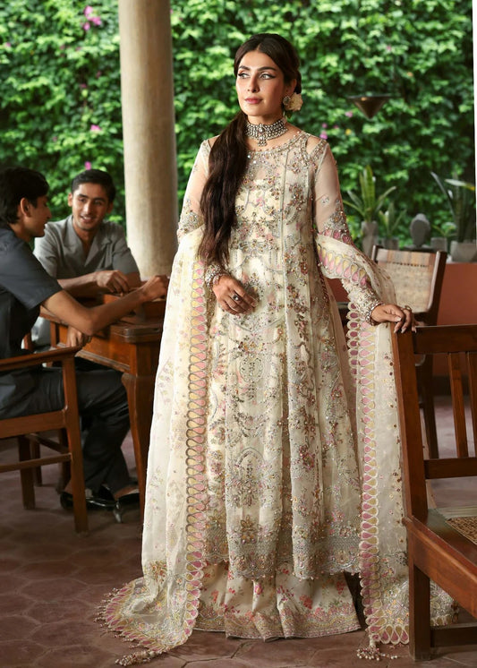 Ethereal ivory frost suit with hand-embellished organza panels, ornate borders, embroidered dupatta, and printed trouser for timeless elegance.