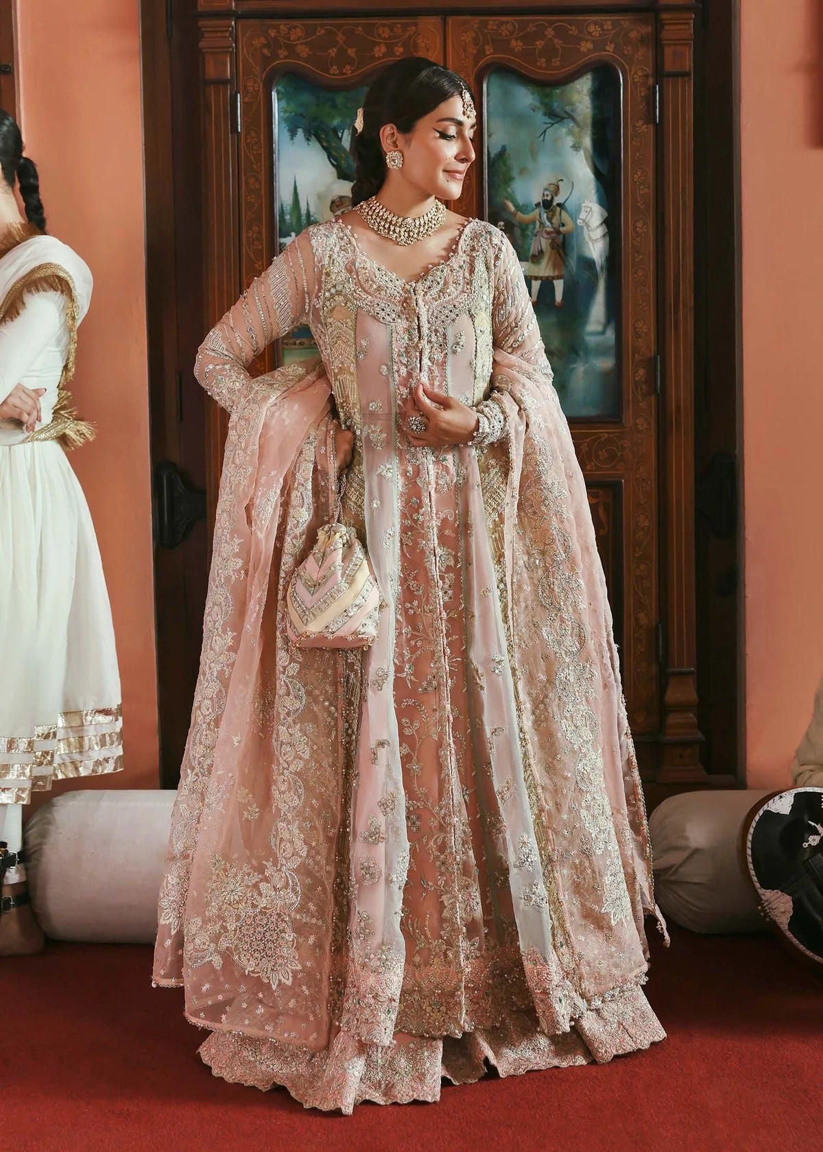 Stunning jewel-toned lehenga suit with hand-embellished shirt, embroidered borders, and organza dupatta for a regal festive look.