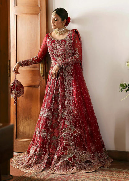Regal crimson lehenga with hand-embellished panels, ornate borders, embroidered dupatta, and net body—perfect for festive and wedding elegance.