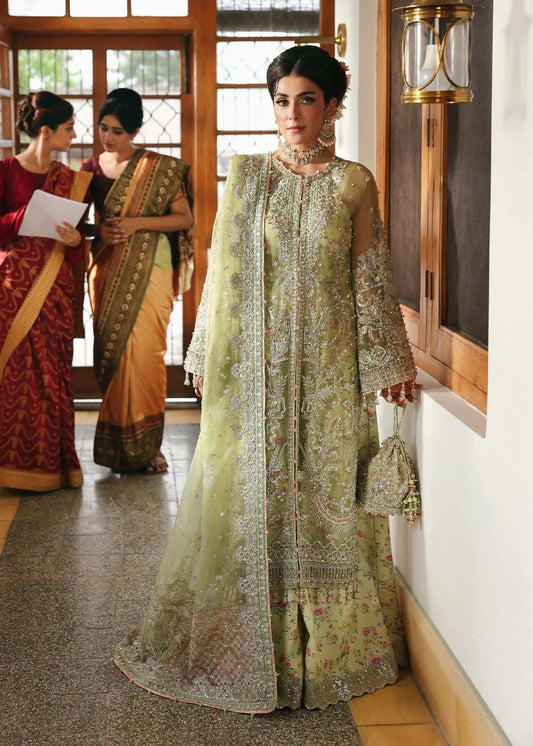 Vibrant parrot jade suit with hand-embellished organza panels, embroidered dupatta, and printed trouser—perfect for festive elegance.