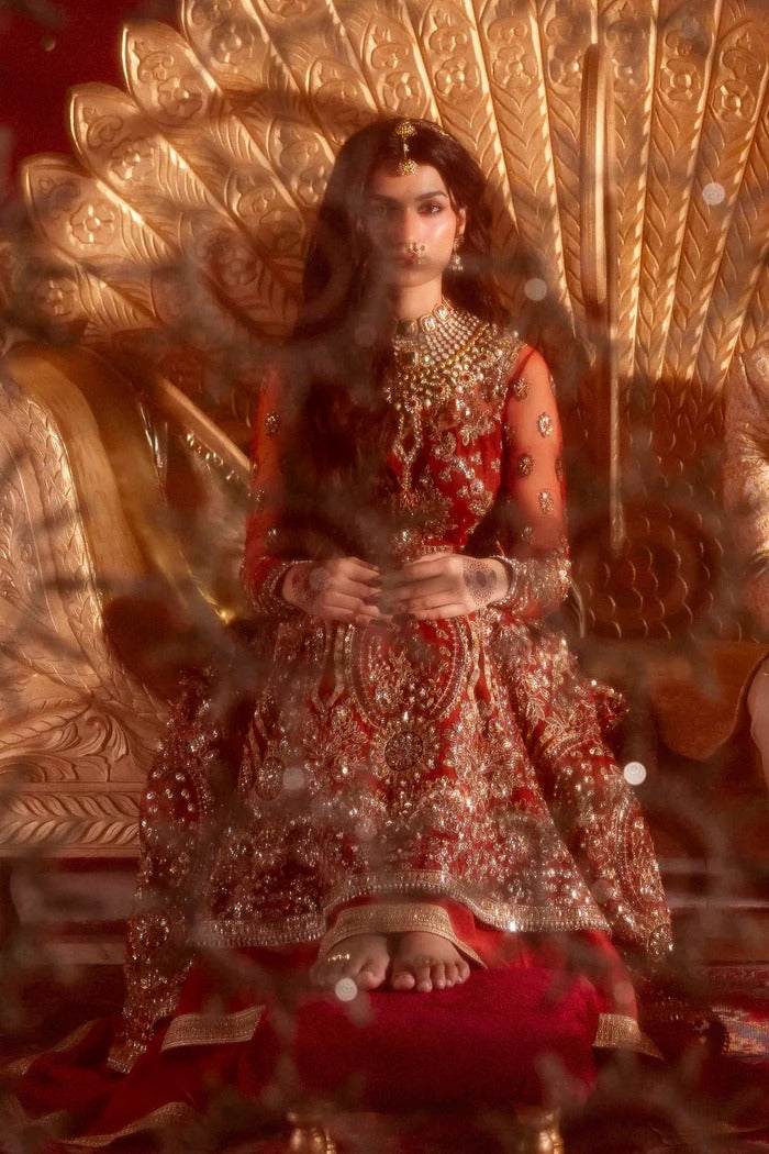 Elegant net dress with hand-embellished panels, blouse, sleeves & dupatta, paired with raw silk inner—crafted for refined beauty and timeless charm.