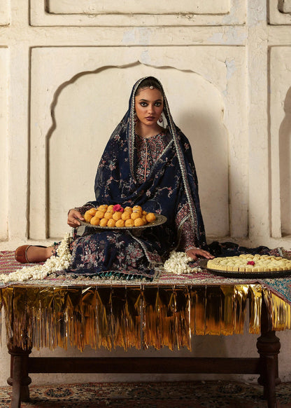 Elegant navy blue chiffon shirt with rich embroidery, silk churidar, and chiffon dupatta. Unstitched festive outfit blending modern grace and timeless charm.