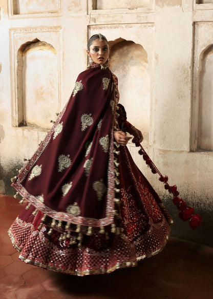 Elegant burgundy and maroon Korean raw silk pishwas with rich embroidery and matching churidar. Unstitched luxury outfit for timeless royal grace.