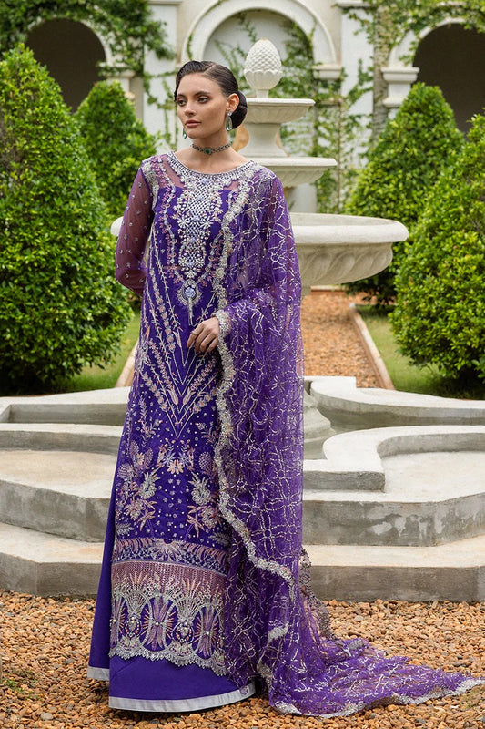 Luxurious purple dress featuring embroidered net shirt, sequined dupatta, raw silk trouser, pearl embellishments, and handmade tassels.