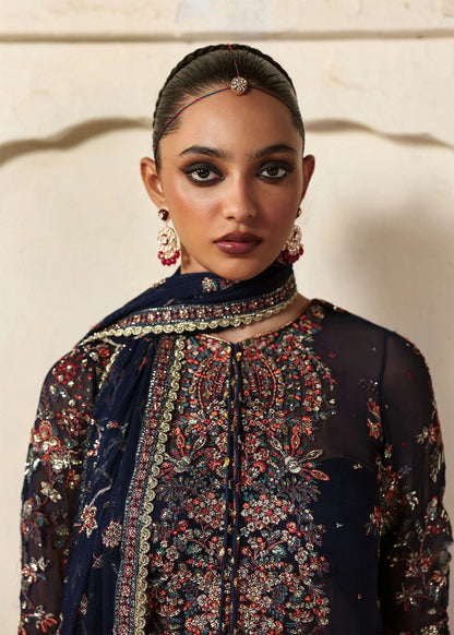 Elegant navy blue chiffon shirt with rich embroidery, silk churidar, and chiffon dupatta. Unstitched festive outfit blending modern grace and timeless charm.