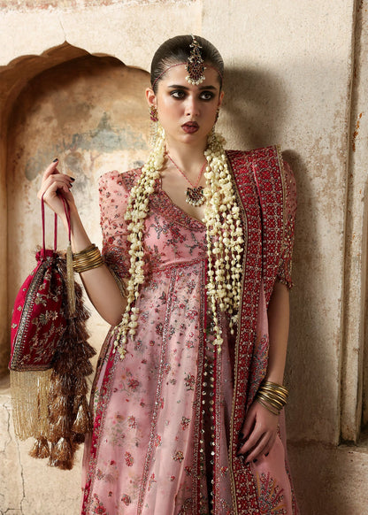 Chic rose pink organza pishwas with embroidered panels, silk lehnga, and chiffon dupatta. Unstitched festive outfit blending elegance with modern charm.