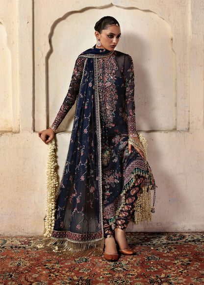 Elegant navy blue chiffon shirt with rich embroidery, silk churidar, and chiffon dupatta. Unstitched festive outfit blending modern grace and timeless charm.
