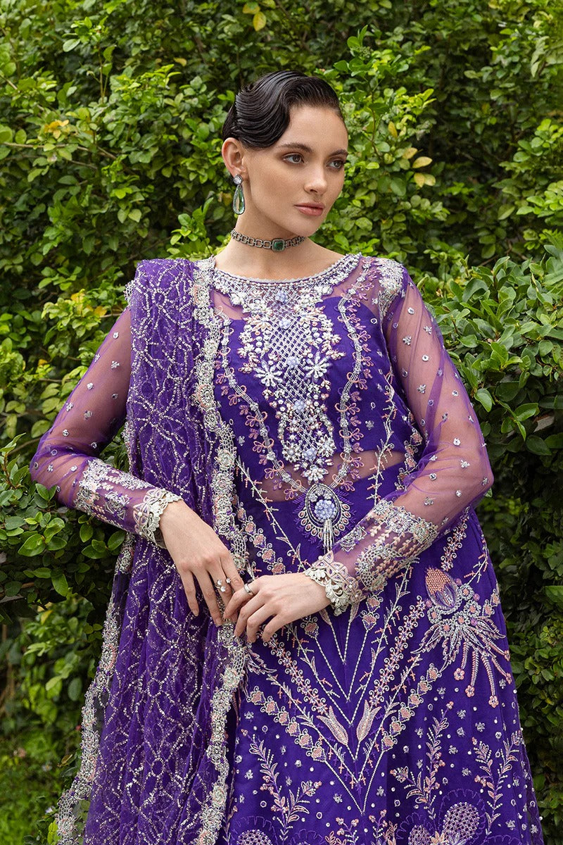 Luxurious purple dress featuring embroidered net shirt, sequined dupatta, raw silk trouser, pearl embellishments, and handmade tassels.