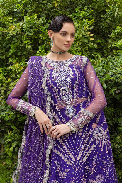 Luxurious purple dress featuring embroidered net shirt, sequined dupatta, raw silk trouser, pearl embellishments, and handmade tassels.