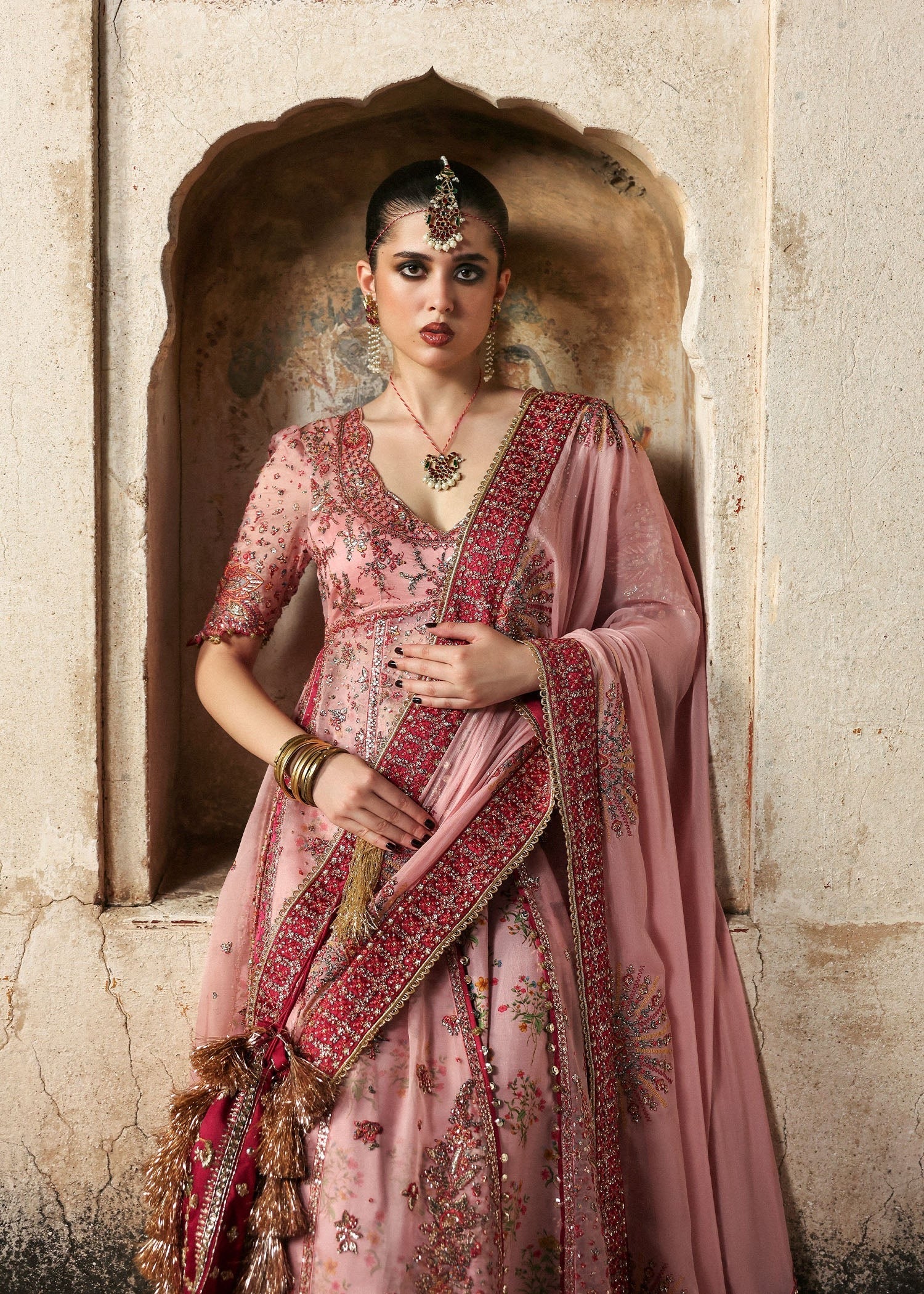 Chic rose pink organza pishwas with embroidered panels, silk lehnga, and chiffon dupatta. Unstitched festive outfit blending elegance with modern charm.