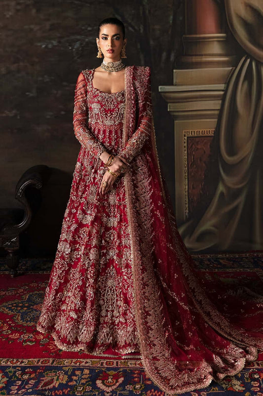 Elegant net suit featuring hand-embellished panels, organza borders, embroidered dupatta, and raw silk trouser — perfect for festive elegance.