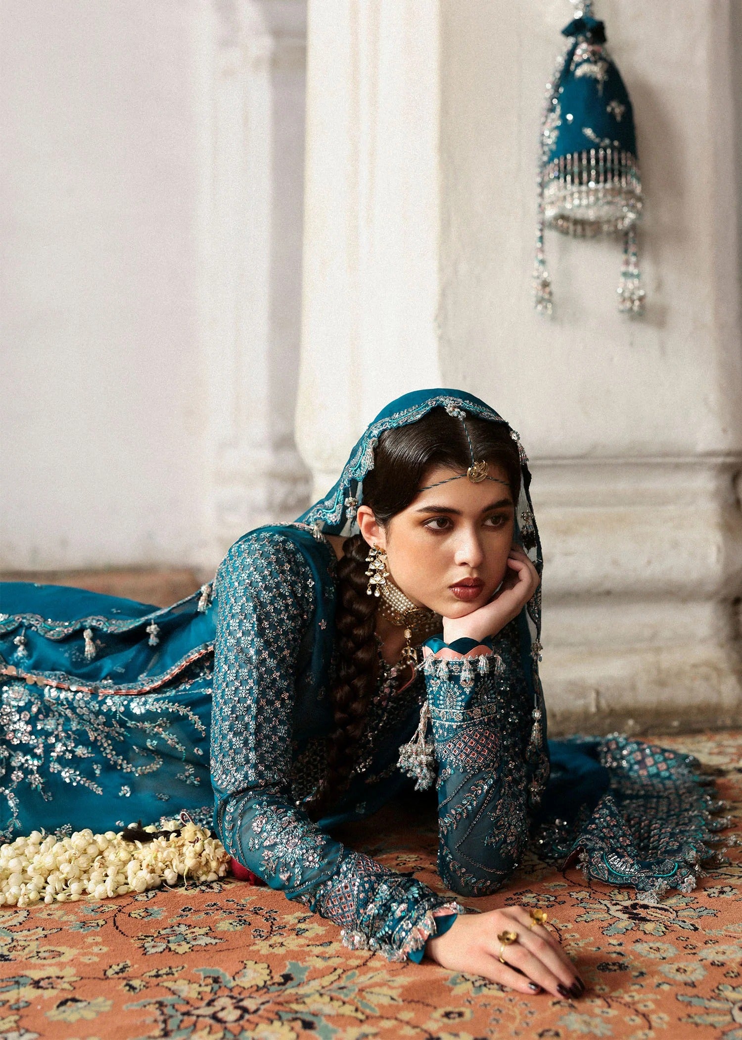 Graceful teal organza shirt with fine embroidery, silk sharara, and chiffon dupatta. Unstitched festive outfit perfect for elegant traditional occasions.