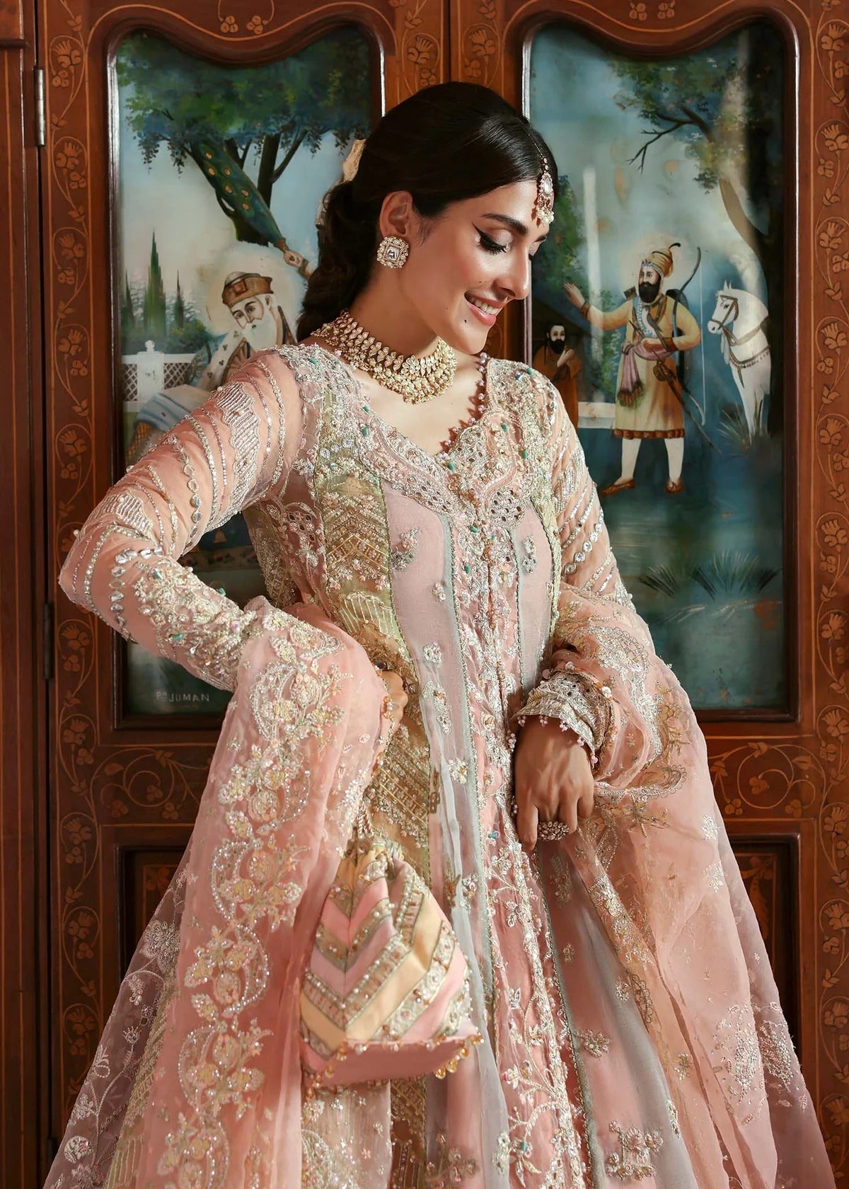 Stunning jewel-toned lehenga suit with hand-embellished shirt, embroidered borders, and organza dupatta for a regal festive look.