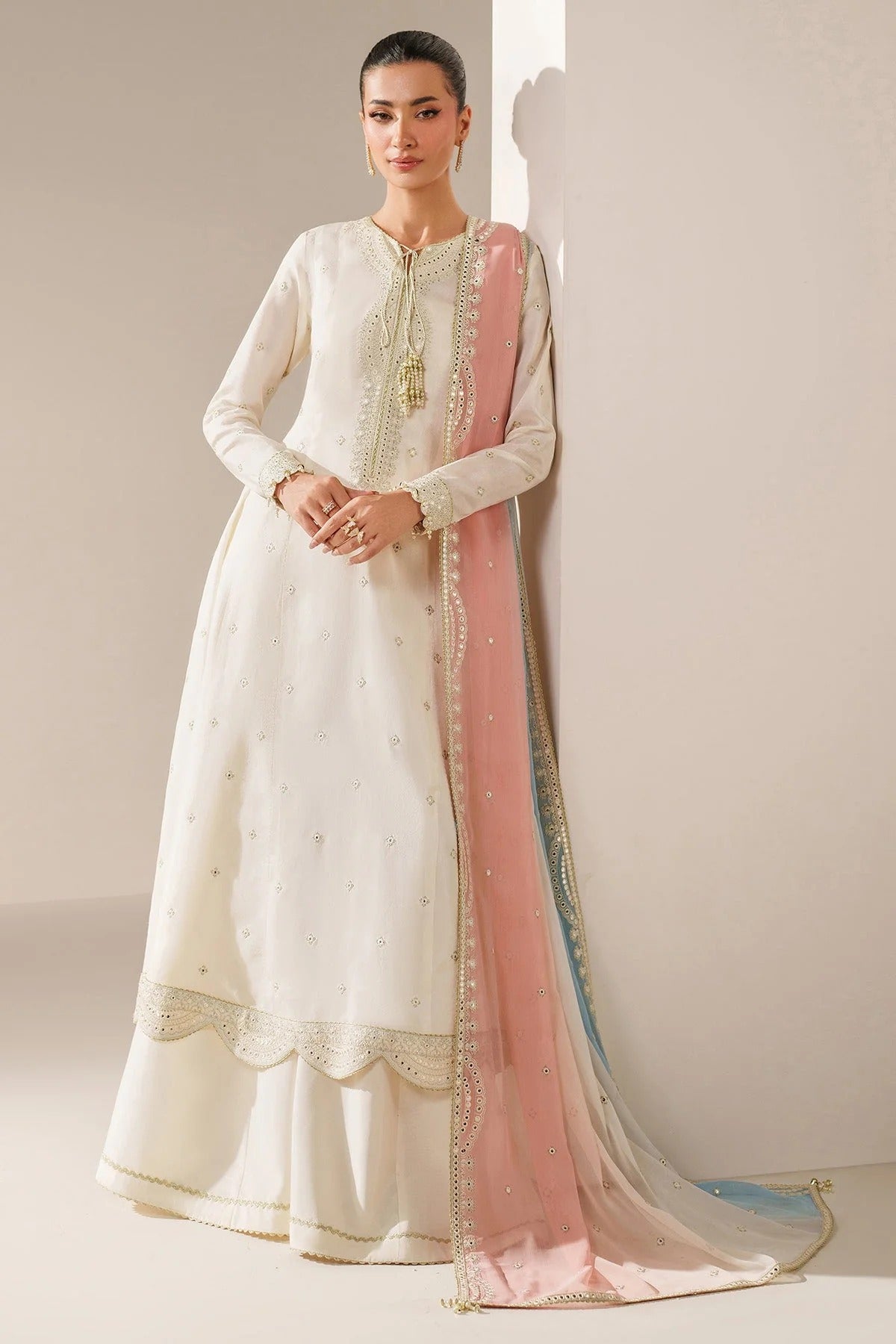 Digitally printed chiffon suit with embroidery on yoke, panels, sleeves & dupatta. Paired with dyed rawsilk bottom for a luxe, elegant formal look.