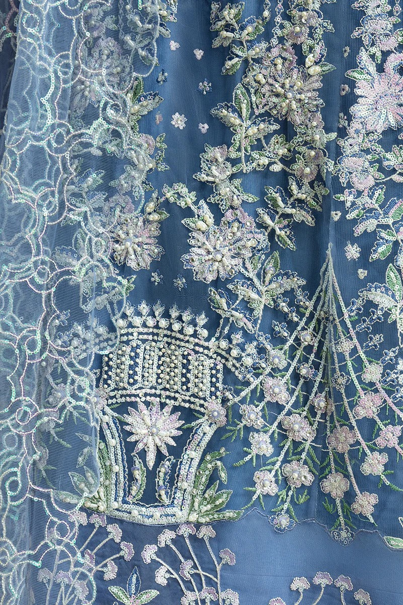 Stunning blue ensemble with embroidered net shirt, sequined dupatta, raw silk trouser, and handmade tassels for a graceful festive look.