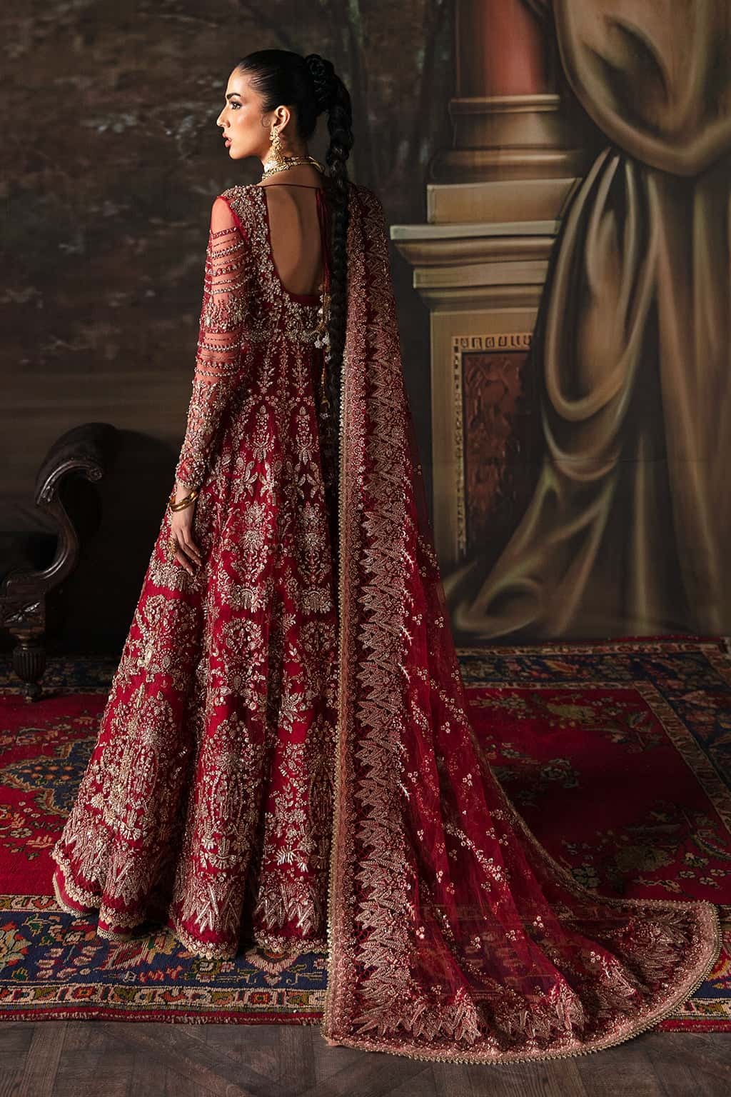 Elegant net suit featuring hand-embellished panels, organza borders, embroidered dupatta, and raw silk trouser — perfect for festive elegance.