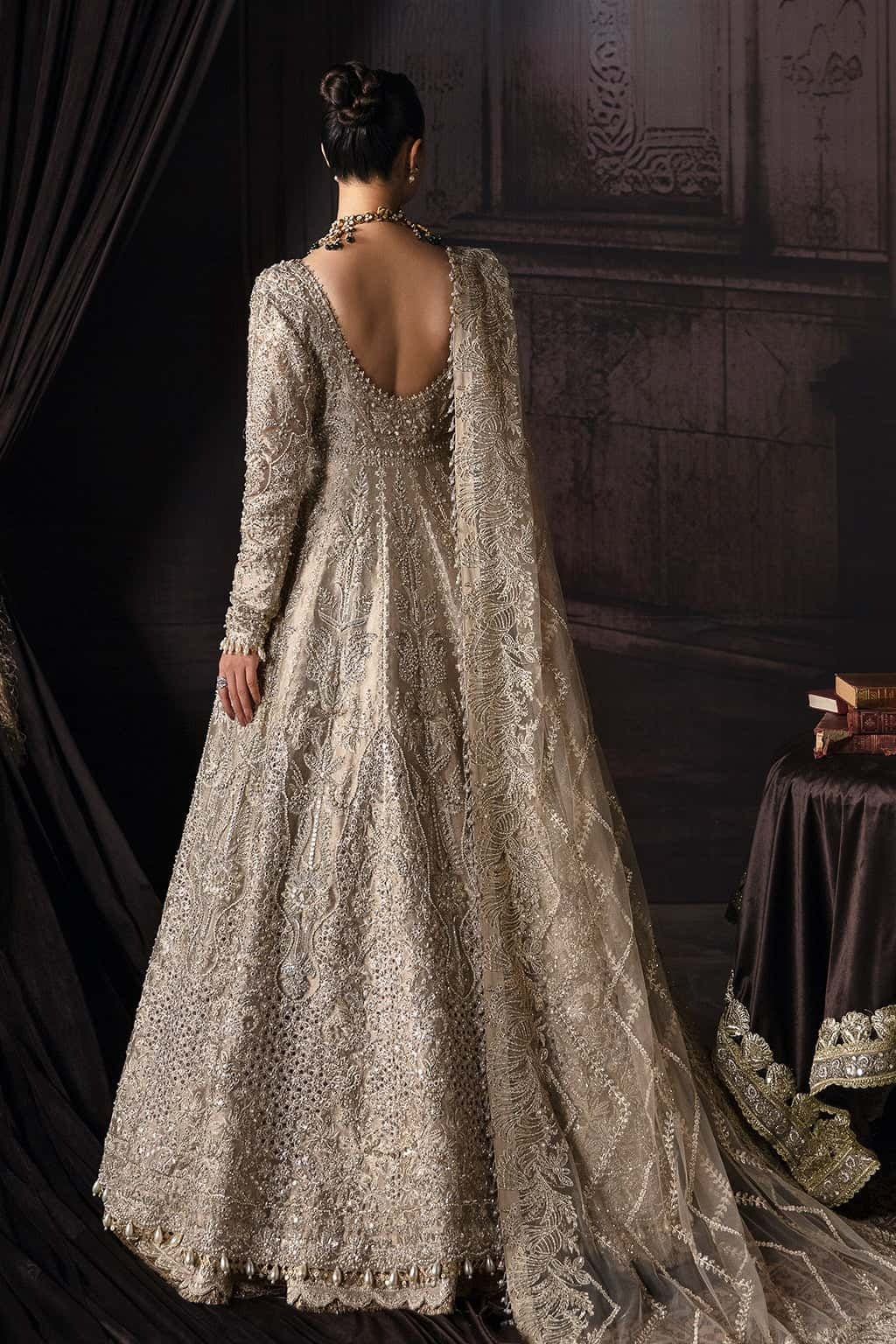 Elegant zari suit featuring hand-embellished panels, embroidered dupatta with borders, and jamavar trouser — perfect for festive and bridal wear.