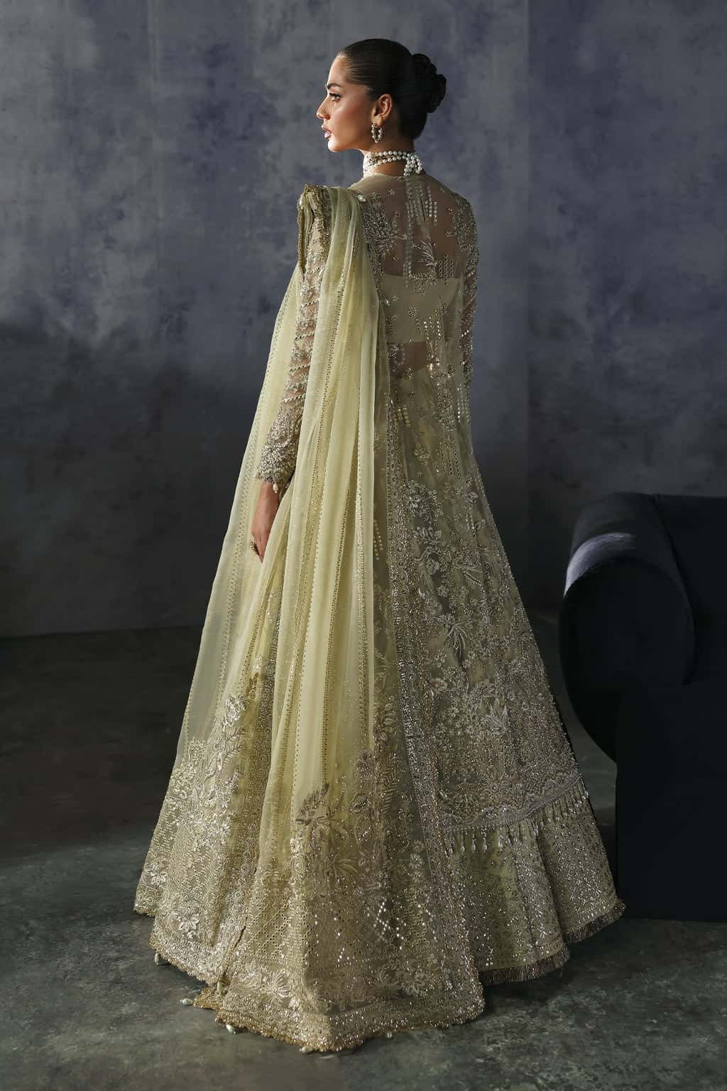 Luxurious organza suit with hand-embellished embroidery, ornate dupatta borders, and embroidered raw silk trouser — perfect for festive elegance.