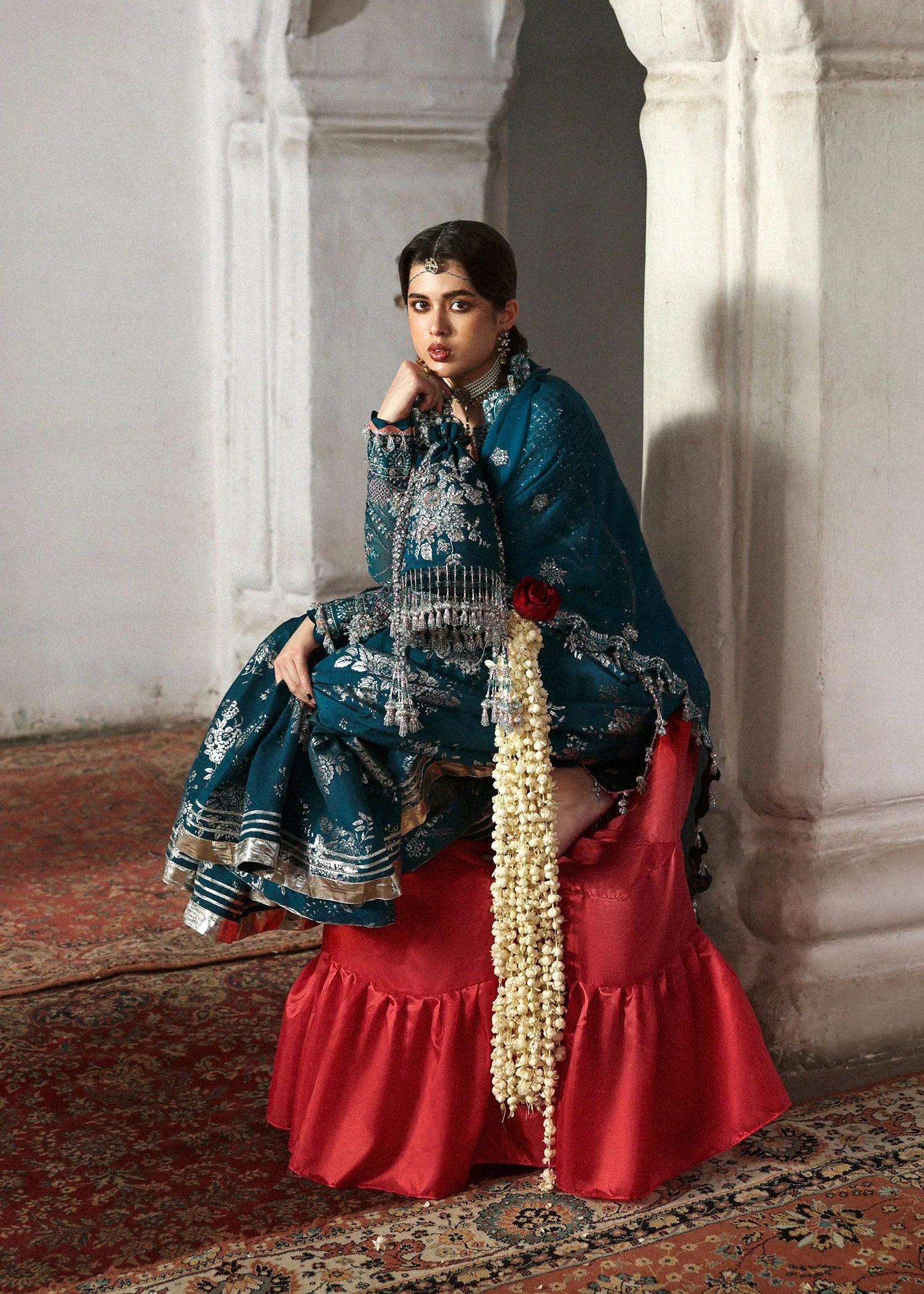 Graceful teal organza shirt with fine embroidery, silk sharara, and chiffon dupatta. Unstitched festive outfit perfect for elegant traditional occasions.