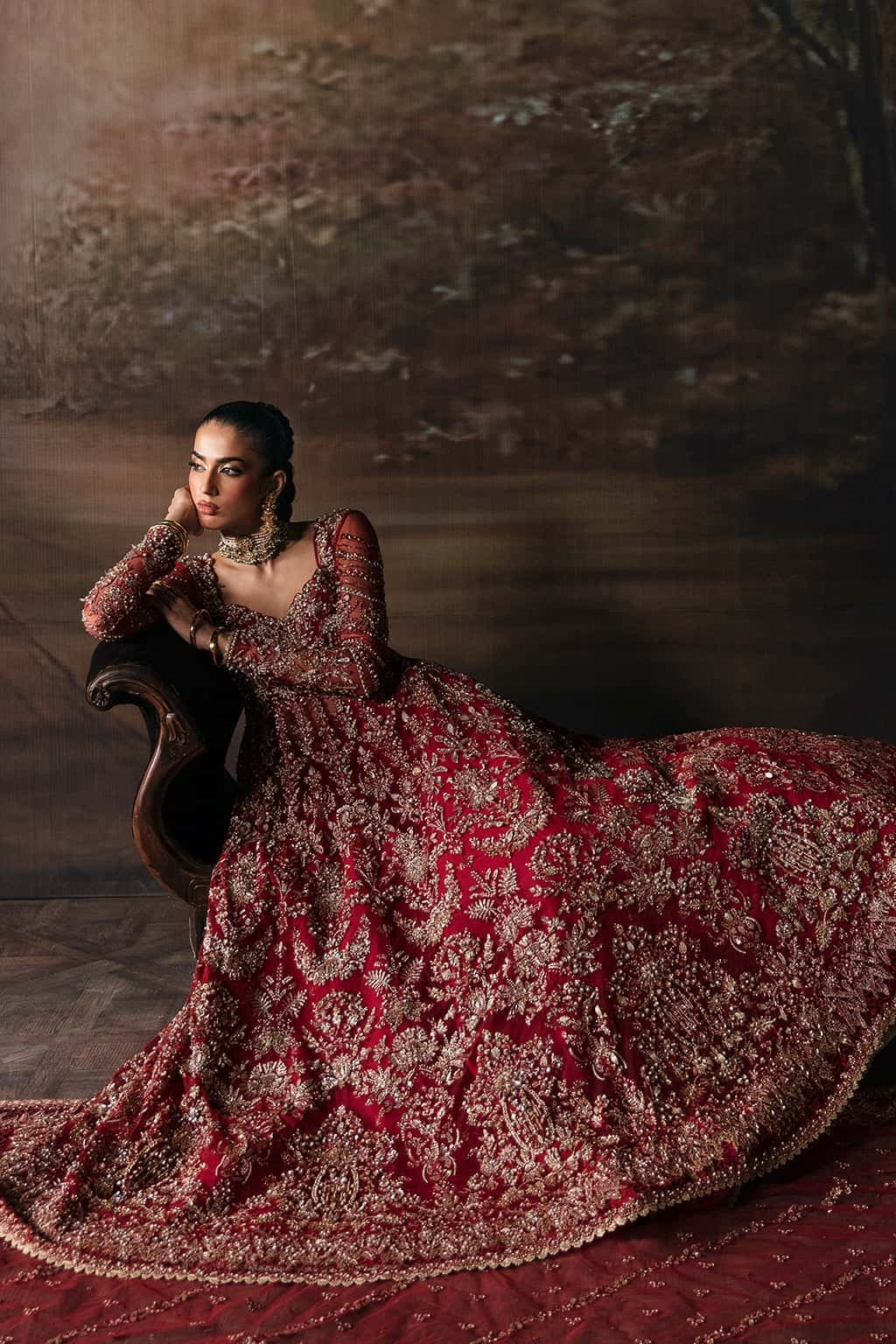 Elegant net suit featuring hand-embellished panels, organza borders, embroidered dupatta, and raw silk trouser — perfect for festive elegance.