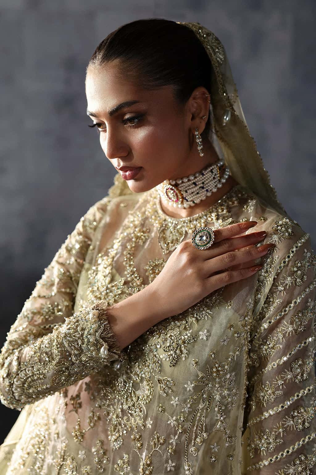 Luxurious organza suit with hand-embellished embroidery, ornate dupatta borders, and embroidered raw silk trouser — perfect for festive elegance.