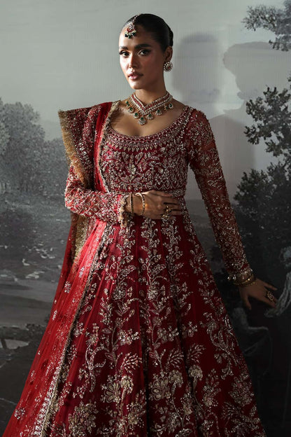 Luxurious net suit with hand-embellished panels, embroidered dupatta with motifs, and raw silk trouser — perfect for weddings and festive wear.