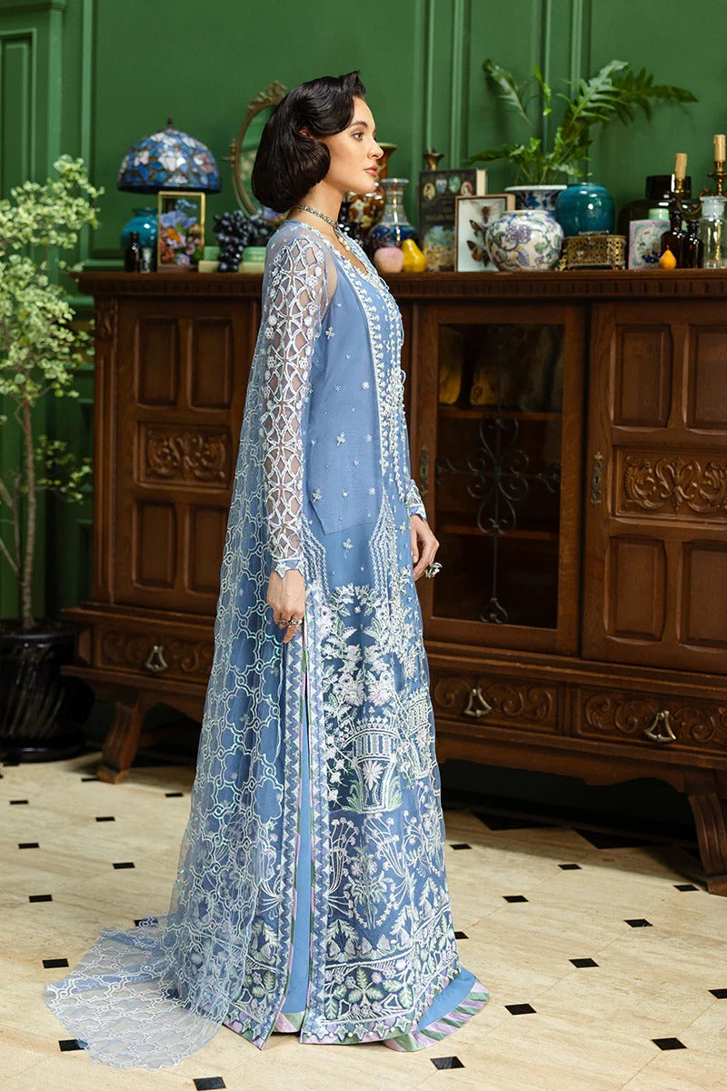 Stunning blue ensemble with embroidered net shirt, sequined dupatta, raw silk trouser, and handmade tassels for a graceful festive look.