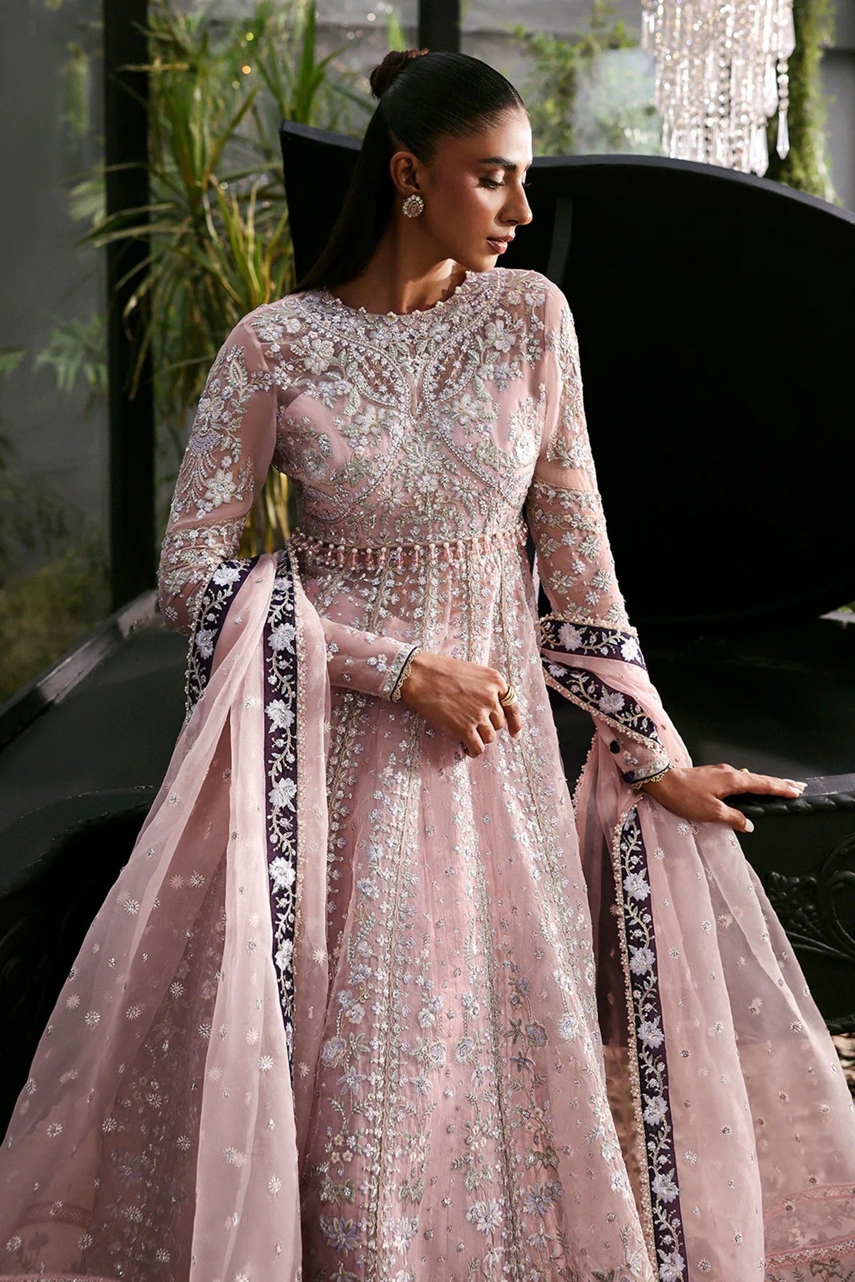 Graceful baby pink organza suit with embroidered panels, purple dupatta borders, and matching trouser — a chic festive and formal ensemble.