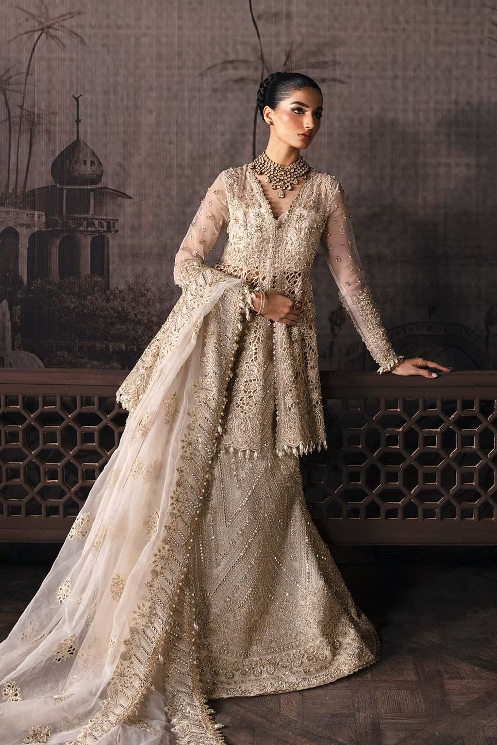 Luxurious organza suit featuring hand-embellished panels, embroidered dupatta, and raw silk trouser — perfect for festive and formal occasions.