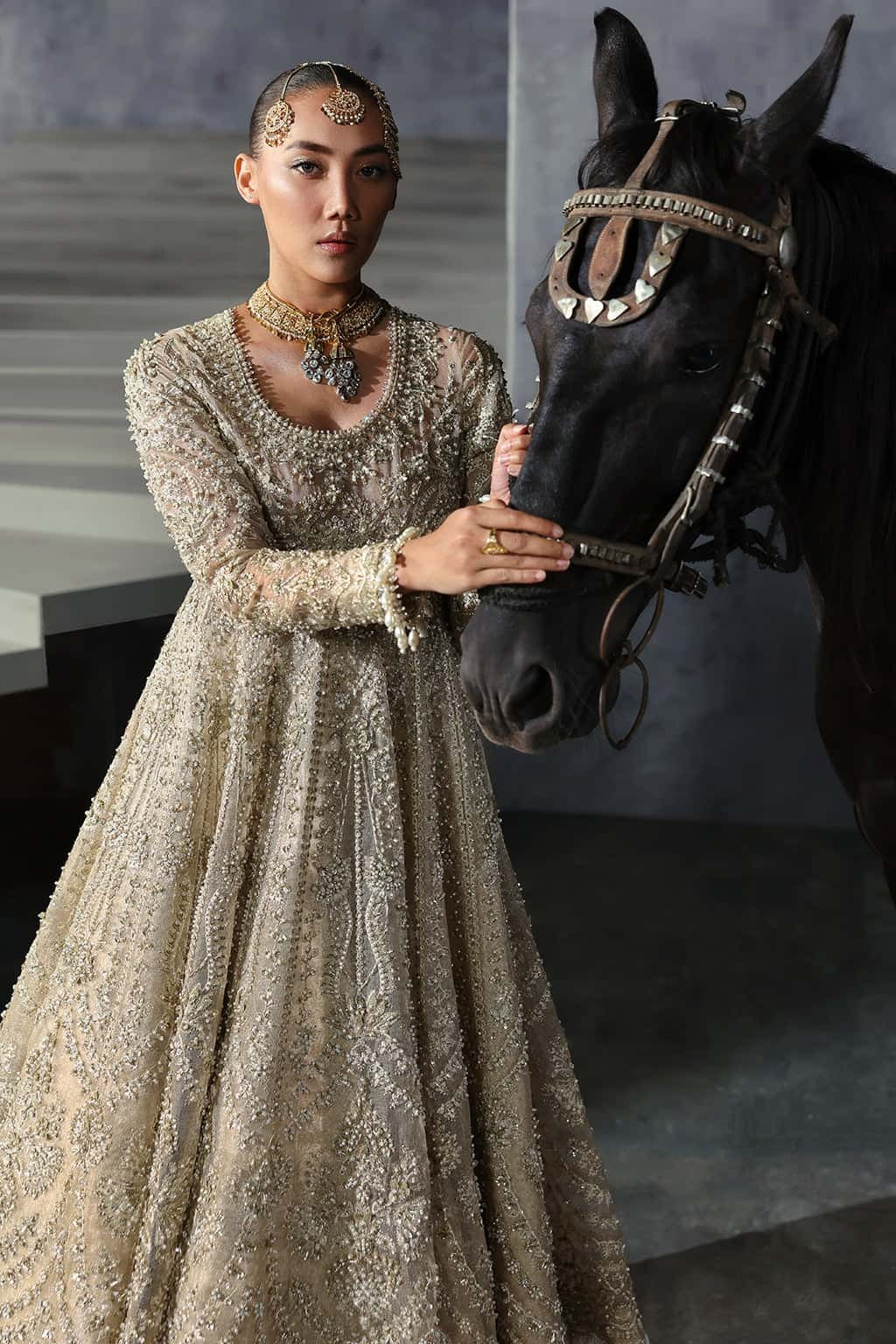 Elegant khaddi net suit featuring hand-embellished panels, embroidered dupatta with four-side border, and jamavar trouser for a timeless festive look.