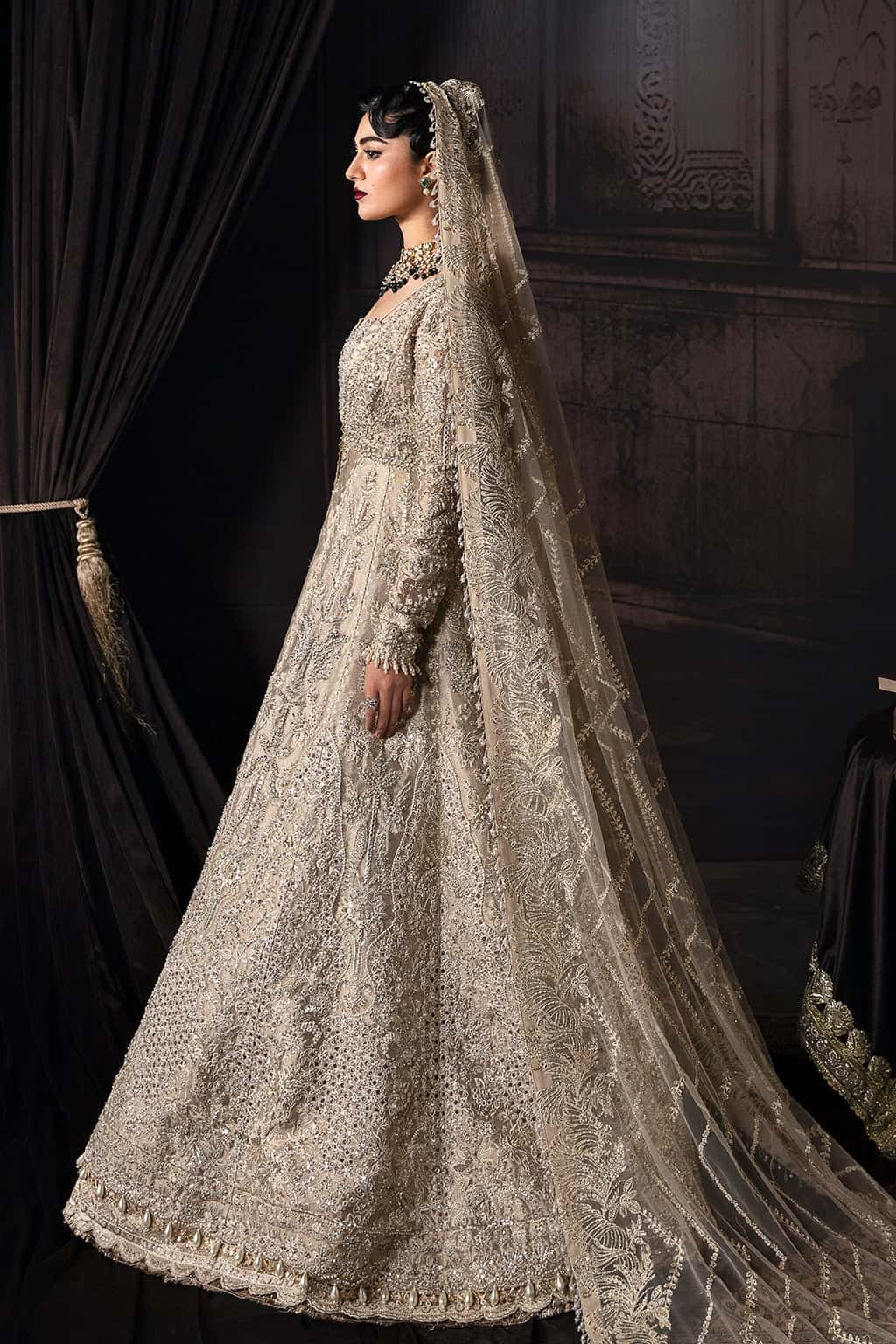 Elegant zari suit featuring hand-embellished panels, embroidered dupatta with borders, and jamavar trouser — perfect for festive and bridal wear.