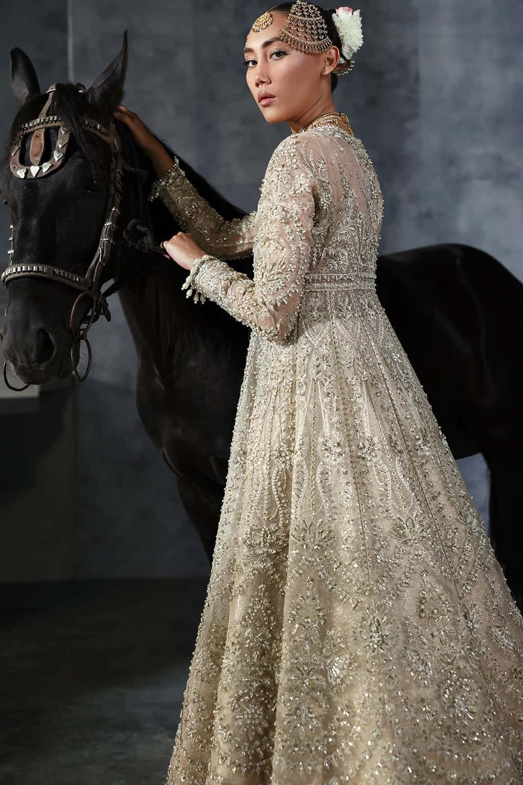 Elegant khaddi net suit featuring hand-embellished panels, embroidered dupatta with four-side border, and jamavar trouser for a timeless festive look.