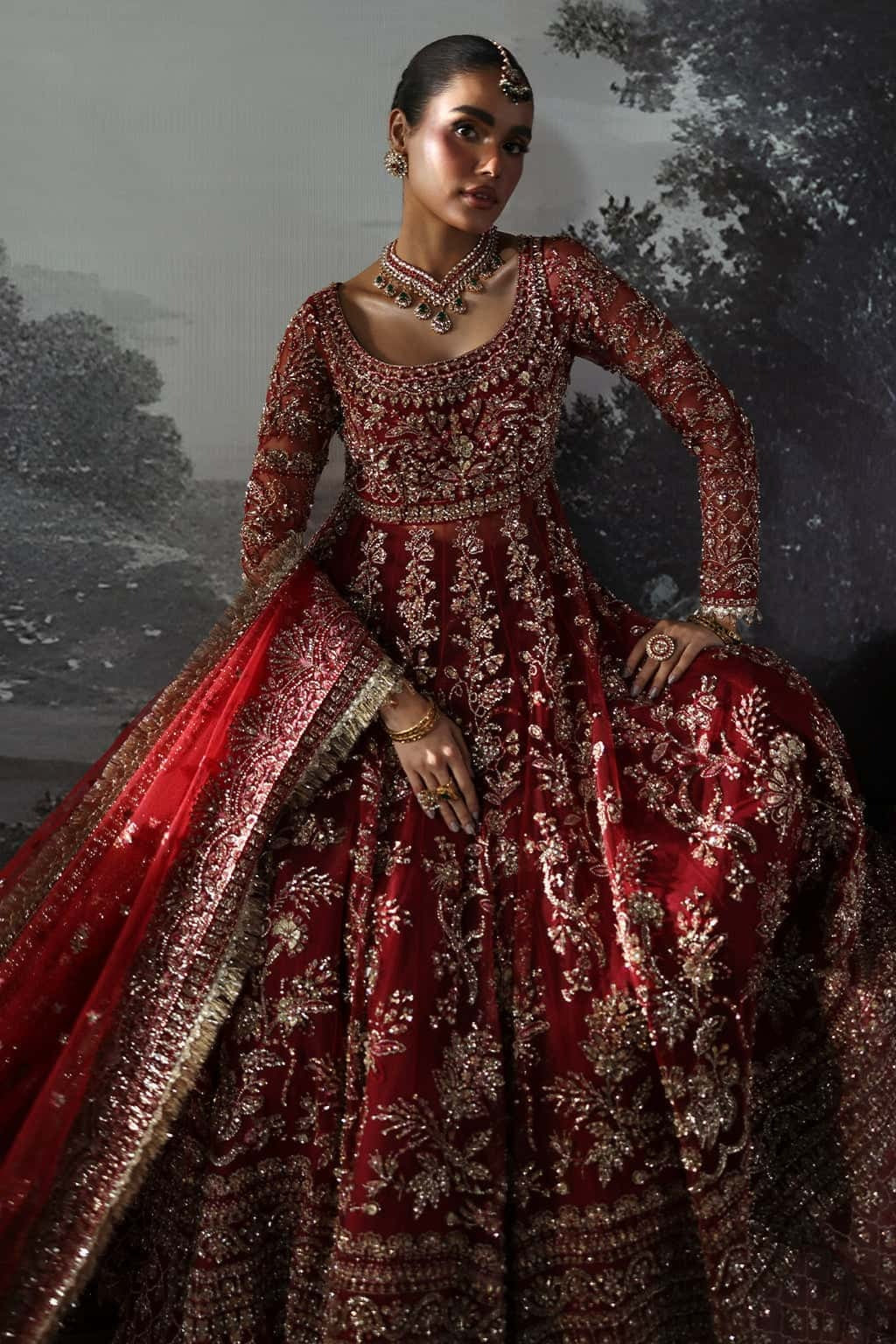 Luxurious net suit with hand-embellished panels, embroidered dupatta with motifs, and raw silk trouser — perfect for weddings and festive wear.