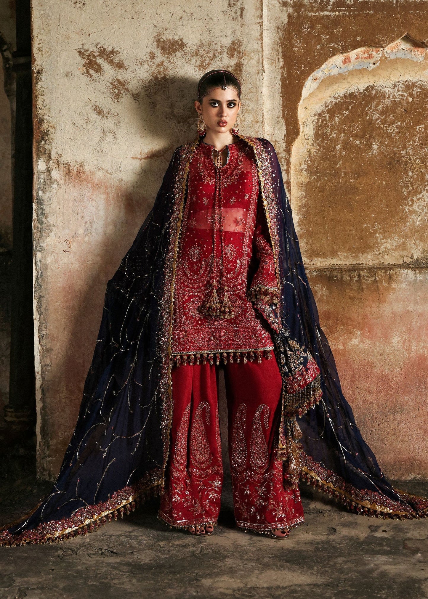 Stunning cherry red chiffon shirt with rich embroidery, silk shalwar, and chiffon dupatta. Unstitched festive outfit radiating elegance and timeless grace.