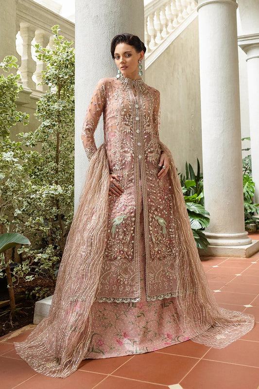 Elegant coral pink lehenga with embroidered net shirt, sequined dupatta, hand embellishments, and handmade tassels for a luxurious festive look.